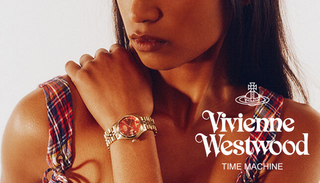 Model wearing Vivienne Westwood unisex watch with red dial and gold bracelet, showcasing bold, fashion-forward style.